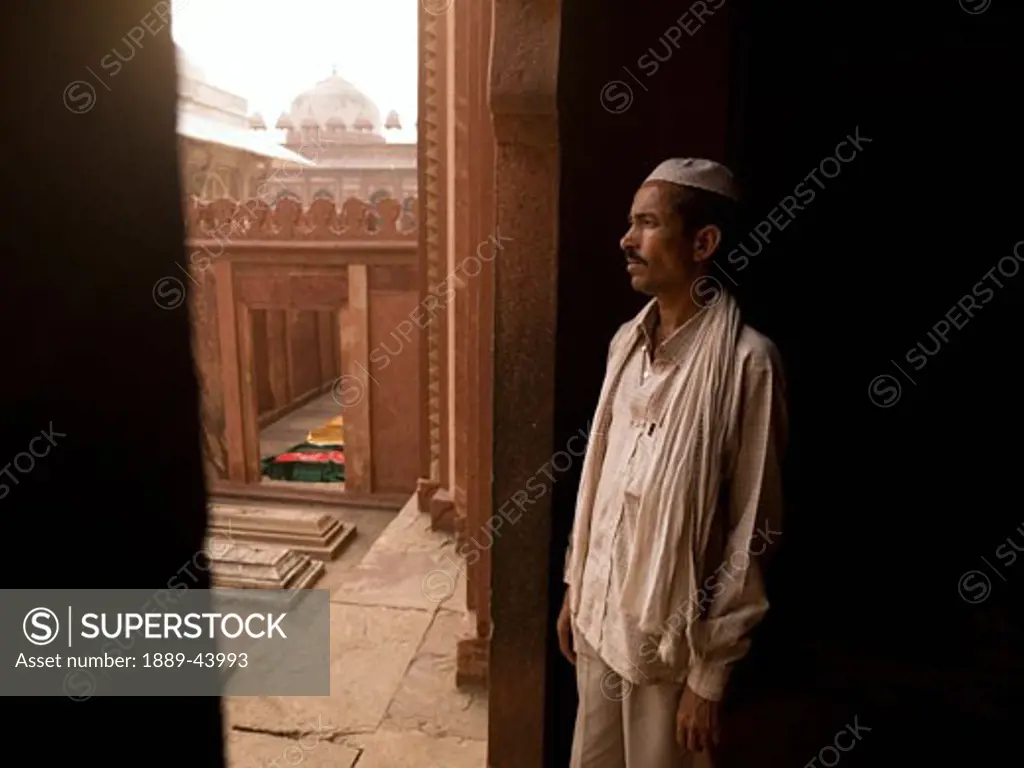 City of Victory,India;Man at doorway looking outside