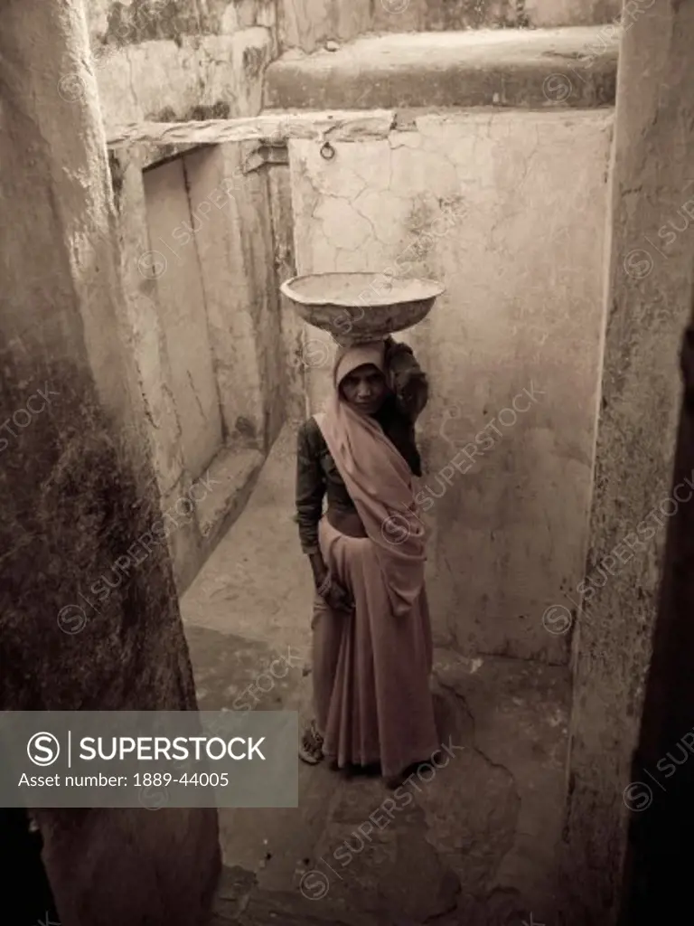 Amber Fort,Jaipur,India;Portrait of woman carrying bowl on top of her head