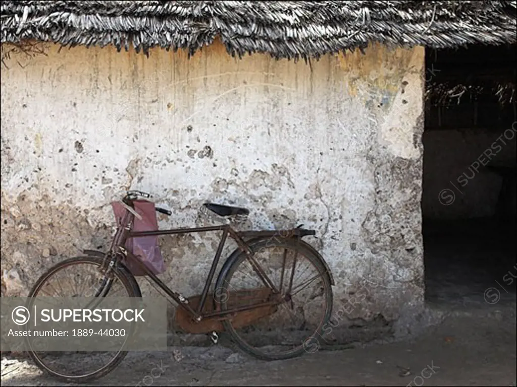 Pwani Mchangani,Zanzibar,Africa;Old bicycle outside stone hut