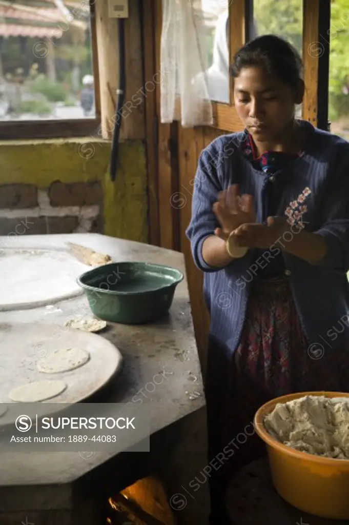 Tecpan,Guatemala;Central America,Young woman cooking traditionally 