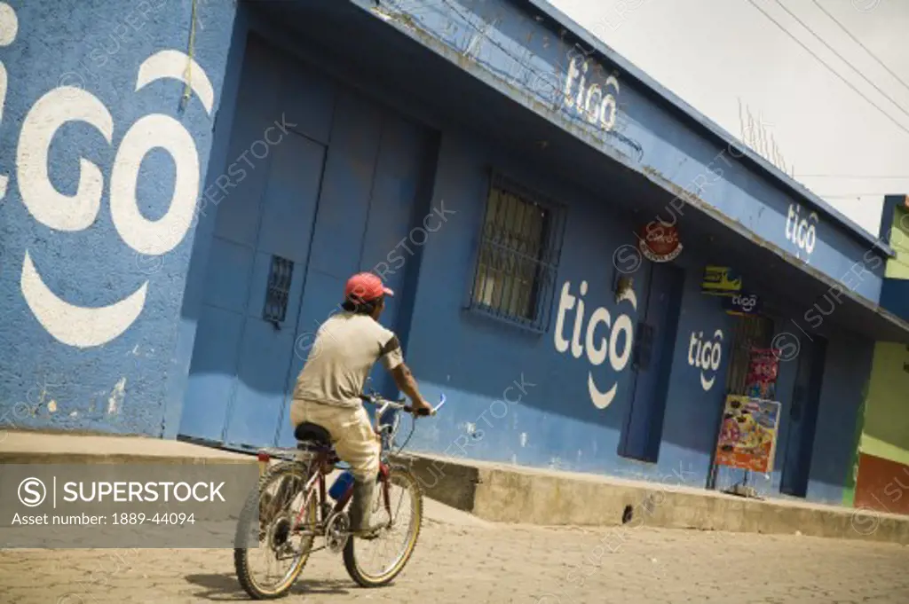 Patzicia,Guatemala;Central America,Man cycling through a shopping district,