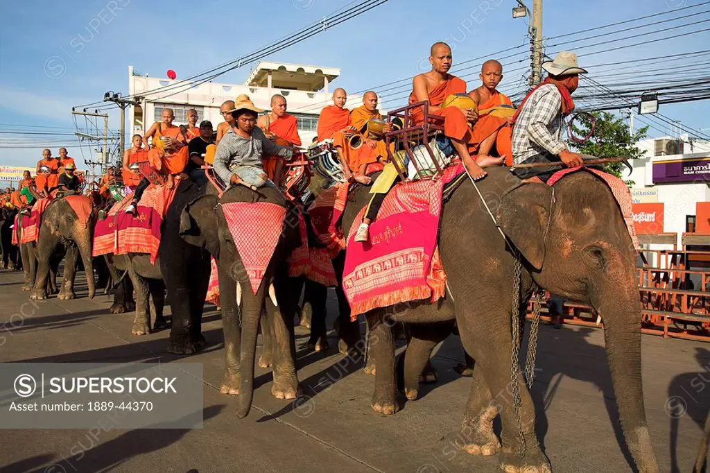 Buddhist monks riding elephants