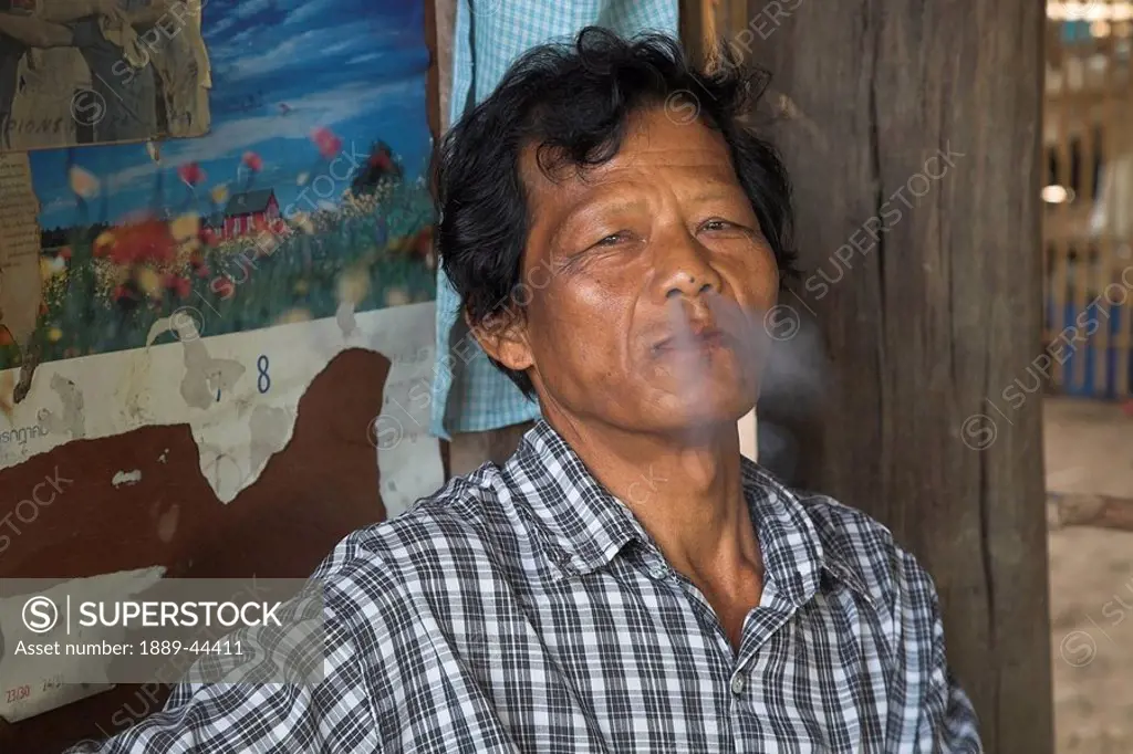 Man smoking outdoors in Thailand
