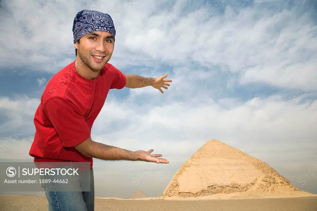 Man showing off Pyramid in background