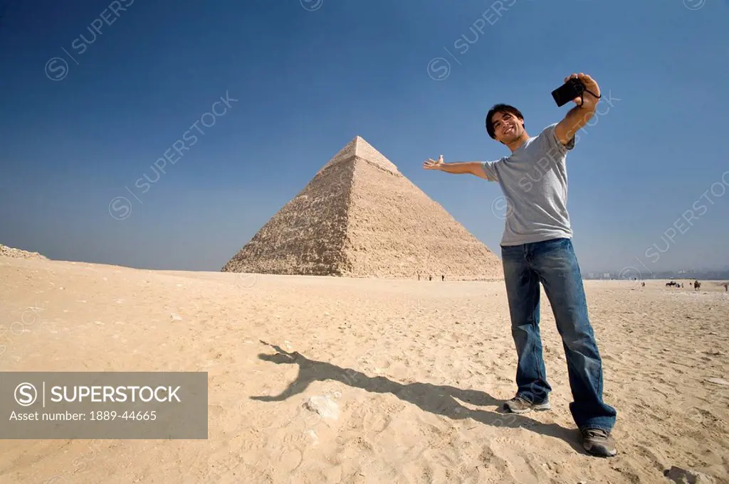 Man taking a picture of himself with Pyramid in background