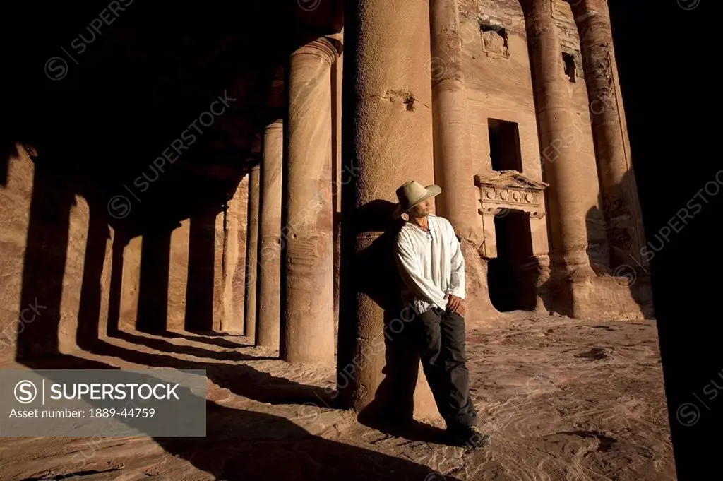 Man standing by royal tomb in Petra
