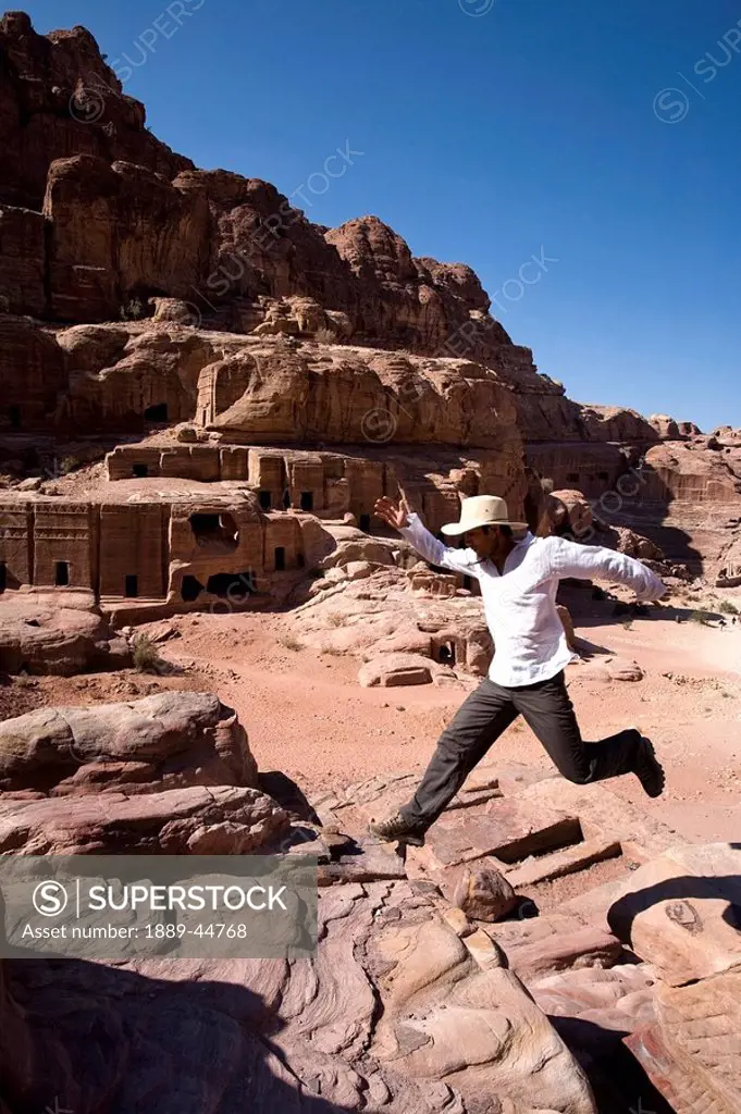 Man jumping near monumental Nabataean tombs