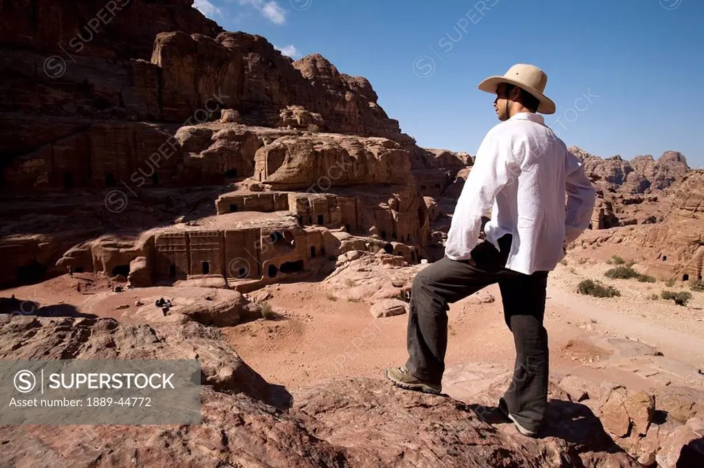 Man standing near monumental Nabataean tombs
