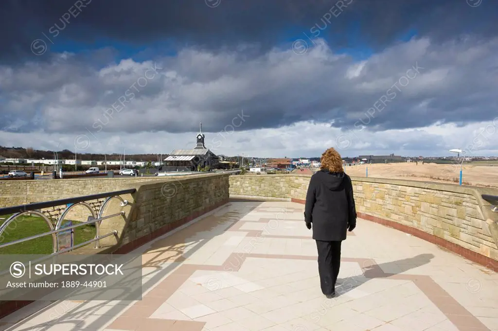 A person on a walkway alone from behind