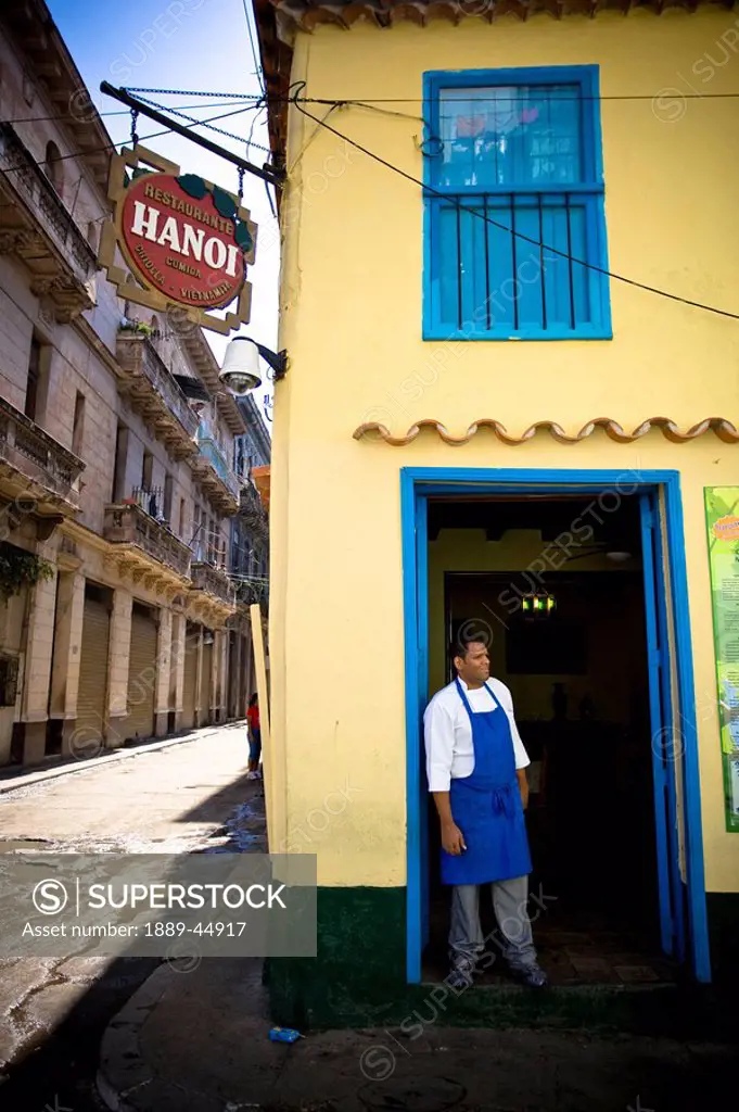 A restaurant in Cuba with a cook standing in the doorway