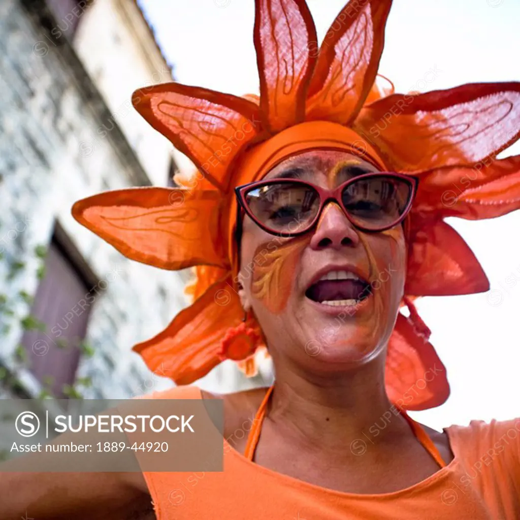 A woman dressed up as an orange flower