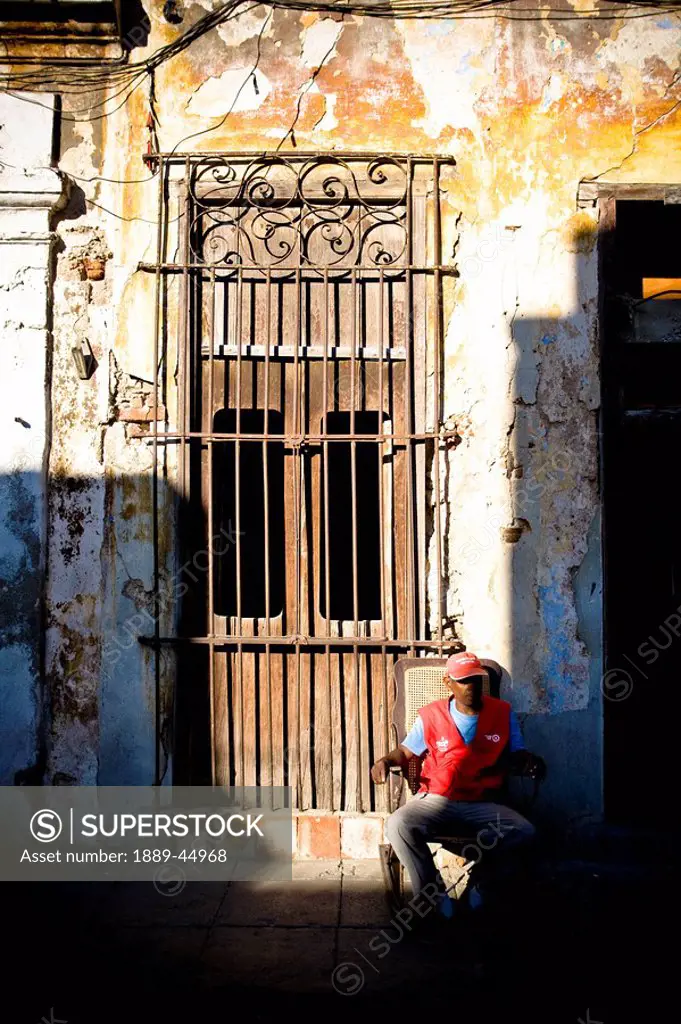 Man sitting by doorway