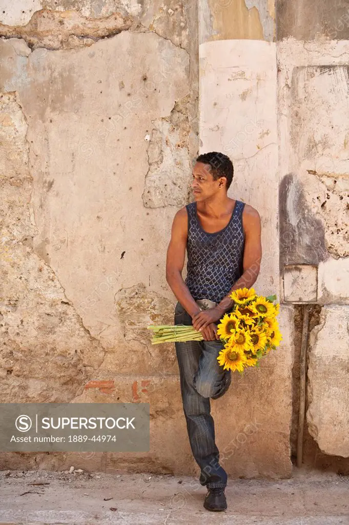 Man with sunflowers in Havana