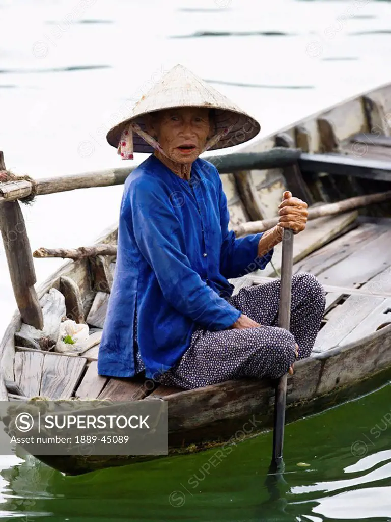 Woman on a small boat in Vietnam