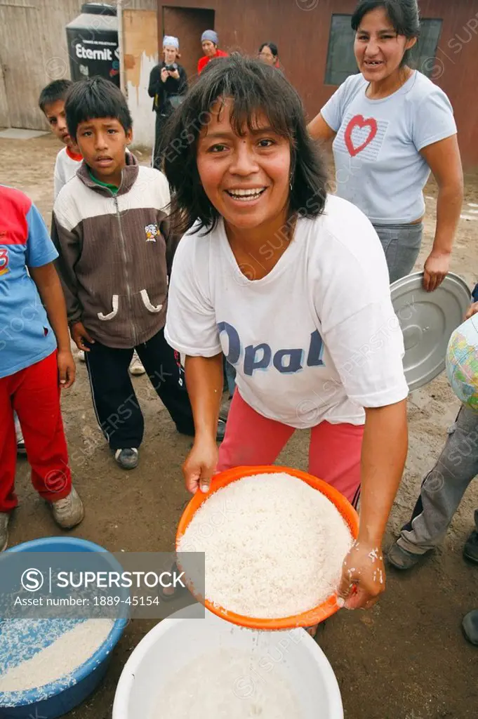 Woman with pan of rice, Lima, Peru