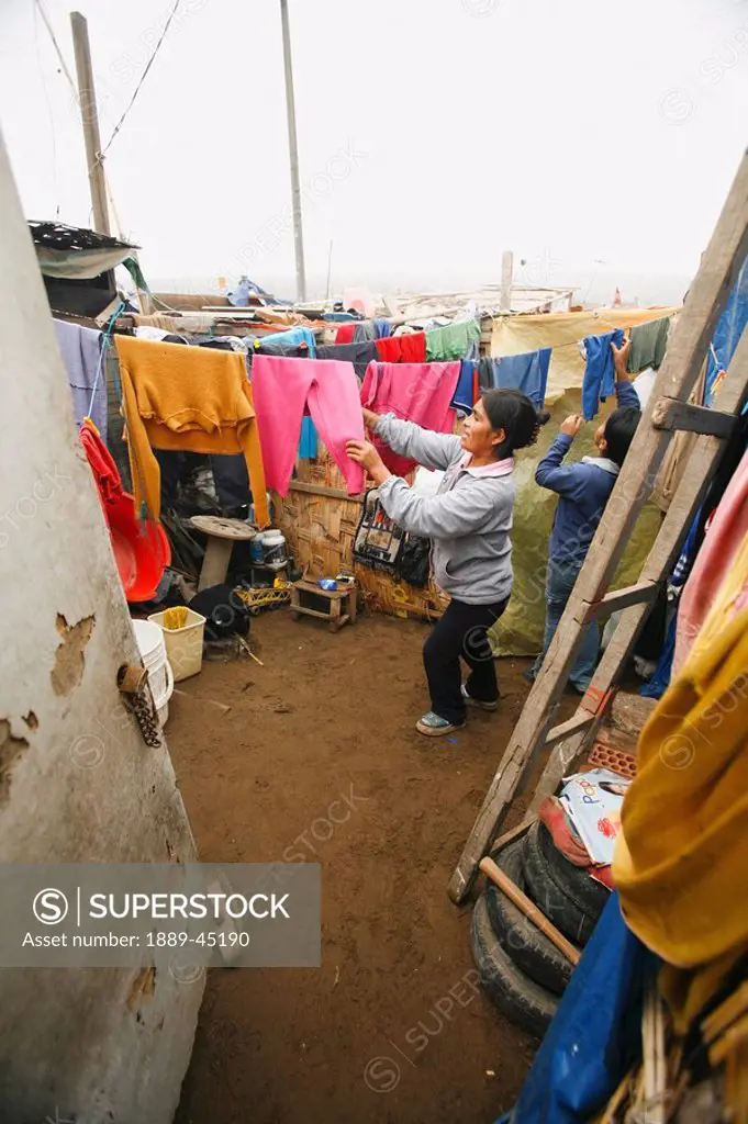 Woman hanging her laundry, Lima, Peru