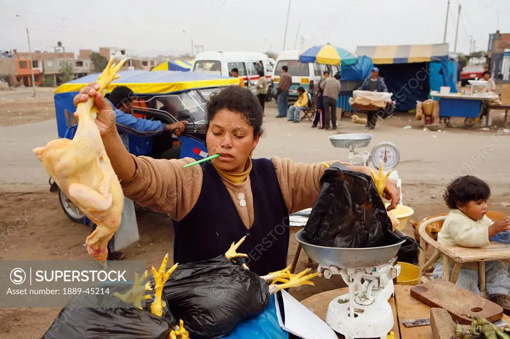 Woman with bags of chickens, Lima, Peru