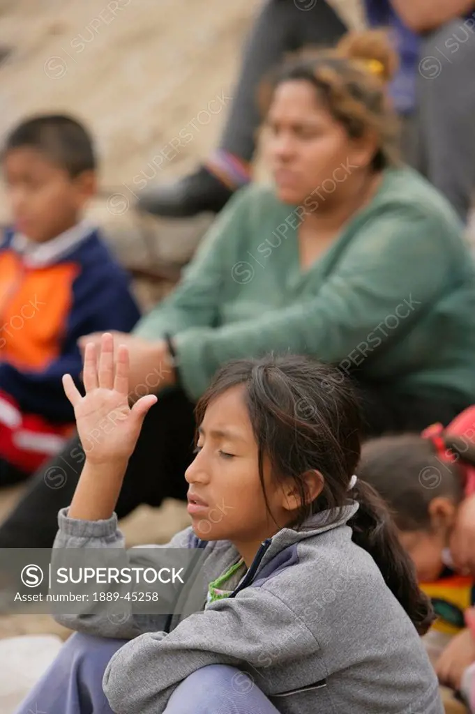 Young girl raises hand, Lima, Peru