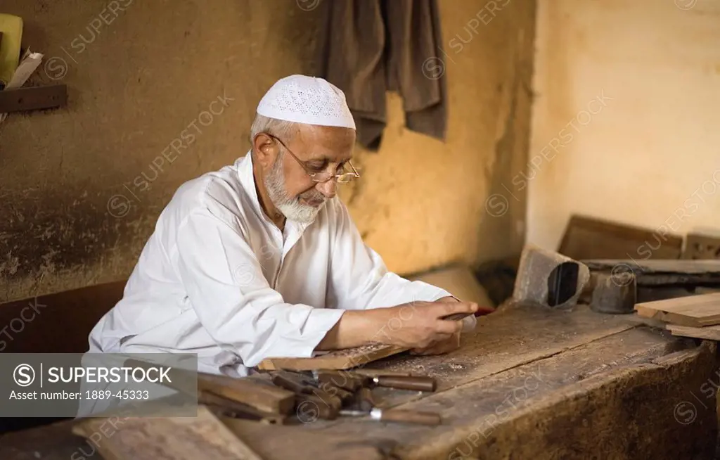 Senior male working with tools