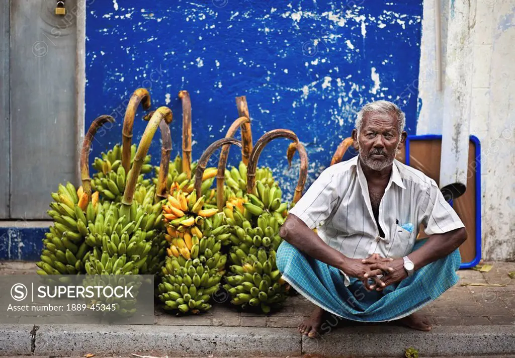 Man sitting in front of fruit