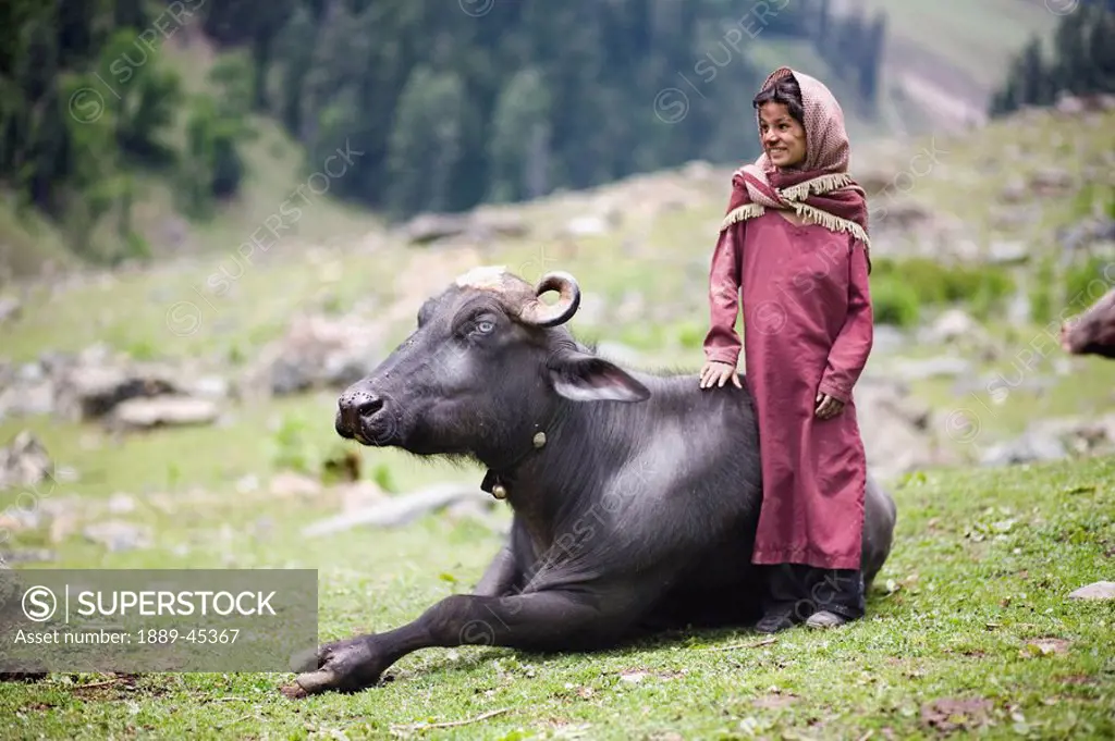 Girl standing next to a bull
