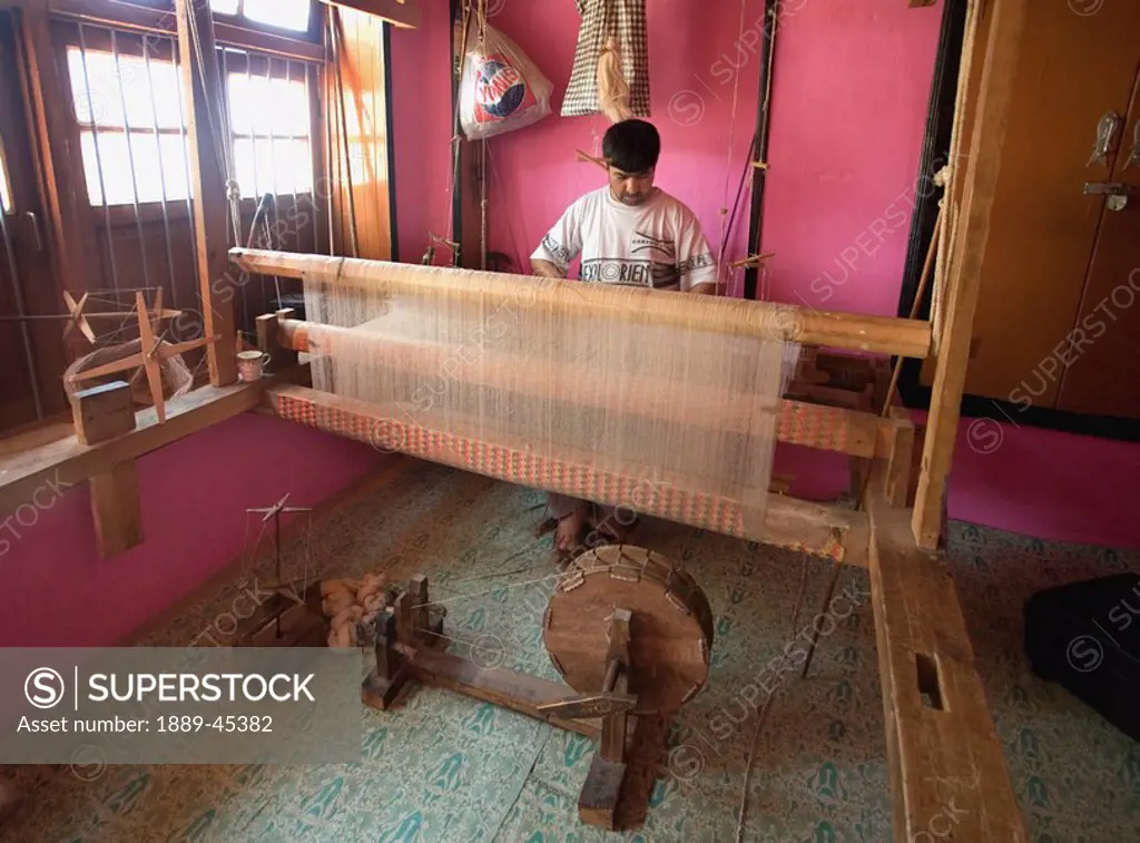Man working on loom