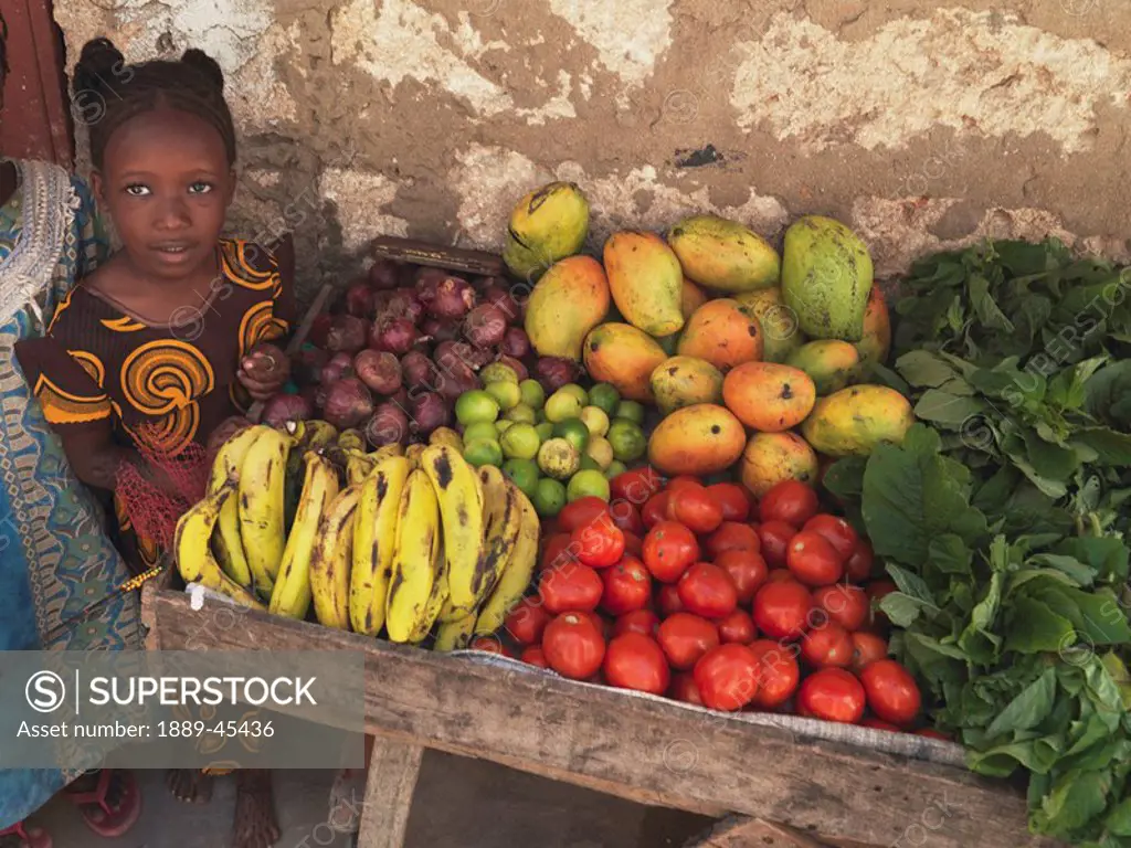 Girl with a cart of fresh produce in Kenya, Africa