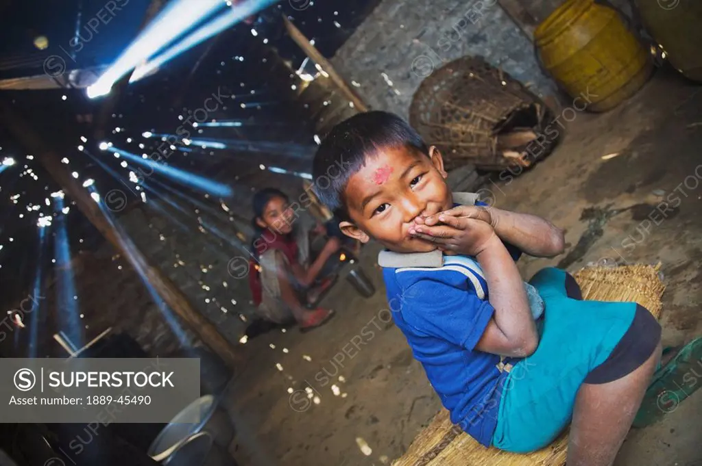 Children in smoky cook shack, Pokhara, Nepal
