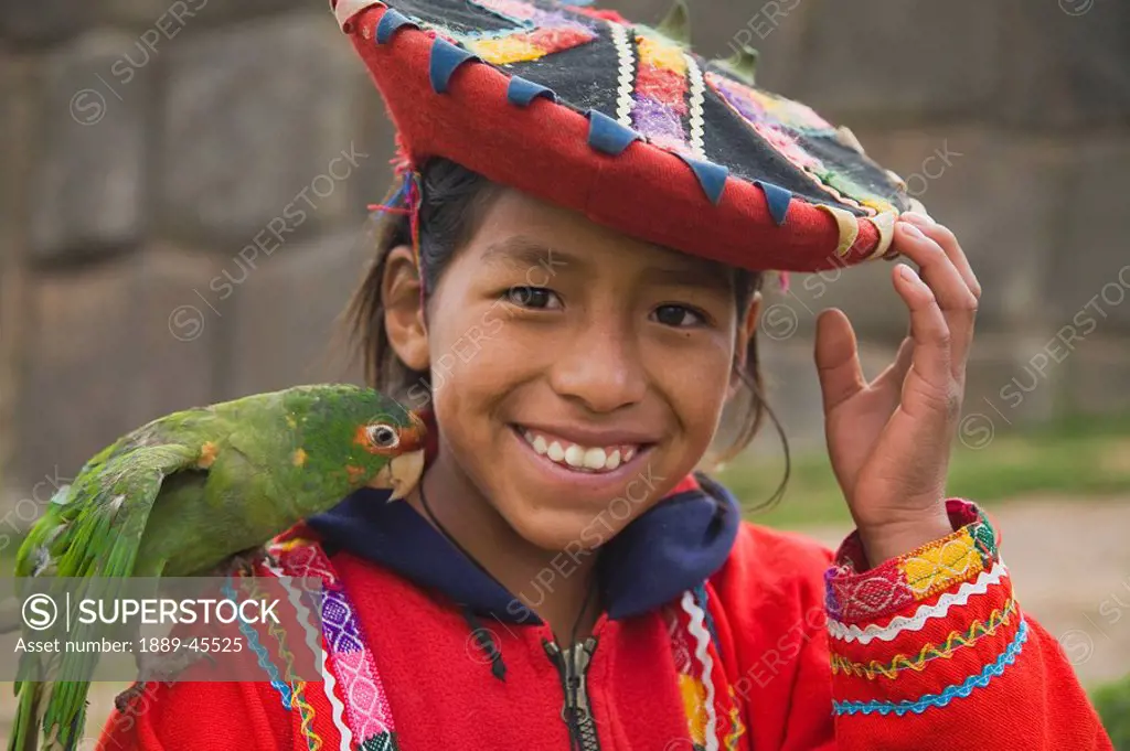 Girl in traditional clothing with parrot, Sacsayhuaman, Cusco, Peru