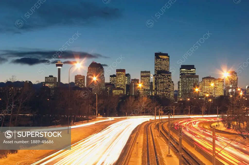 calgary, alberta, canada, skyline at night with car lights on the road