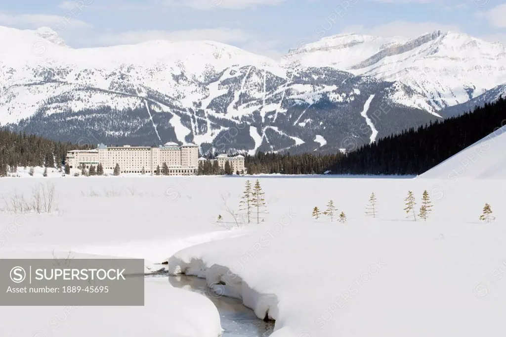 banff national park, alberta, canada, chateau lake louise and a ski hill in winter