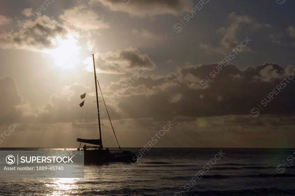 catamaran on the pacific at sunset, north kauai, hawaii, usa