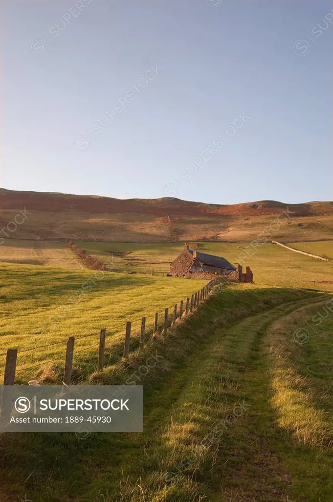 northumberland, england, a farm structure and a fence around a field