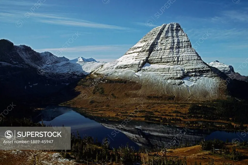 montana, united states of america, a lake reflecting bearhat mountain in glacier national park