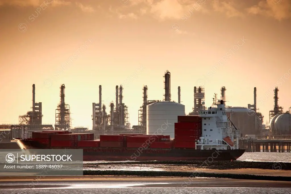 teesside, england, a boat in the water with a refinery in the background along the shore