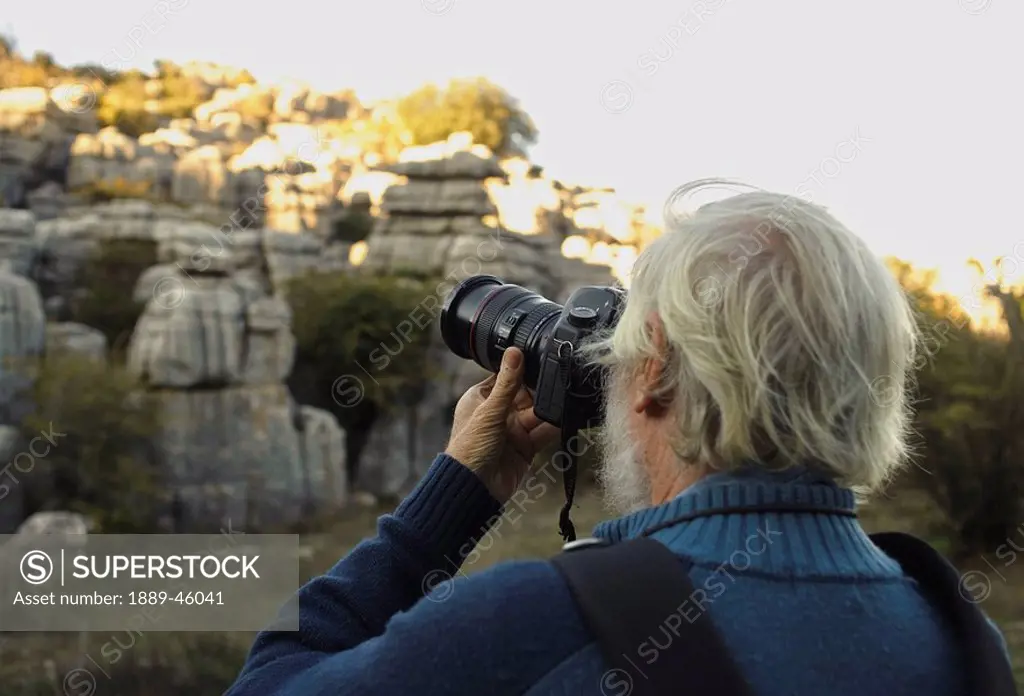 el torcal de antequera, malaga, andalusia, spain, a man photographs rock formations