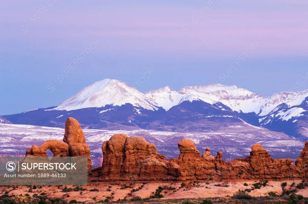 utah, united states of america, twilight wedge penumbra sky above la sal mountains, turret arch and sandstone formations in arches national park