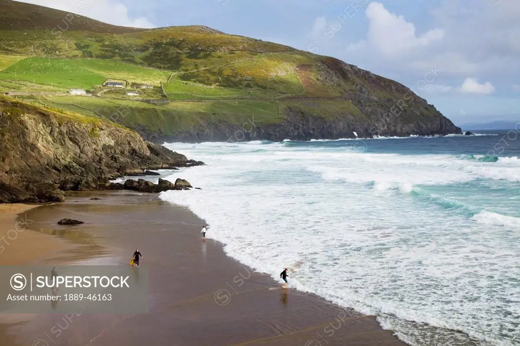 dingle, county kerry, ireland, people playing on coomenoole beach