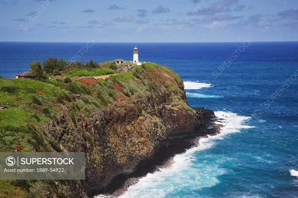 Hawaii, United States Of America, Kilauea Lighthouse On The End Of A Rocky Ridge Jutting Out Into The Pacific Ocean, With Surf Below