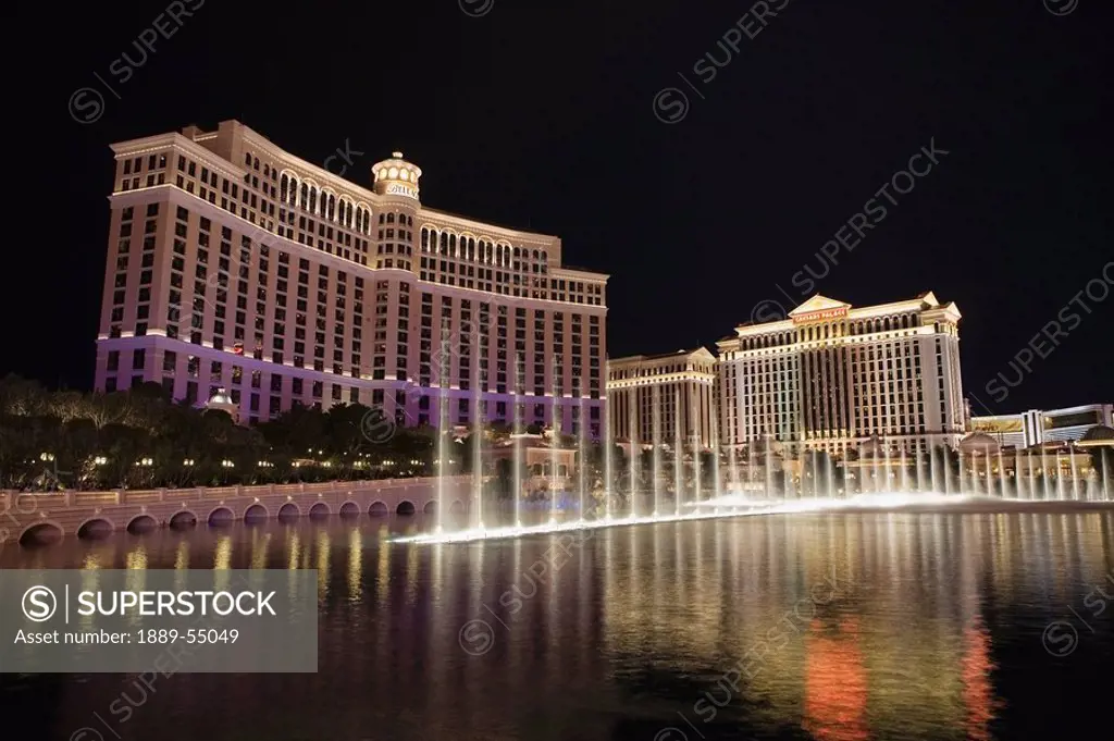 Las Vegas, Nevada, United States Of America, Hotels Illuminated At Night Reflecting In The Water Fountain Pool