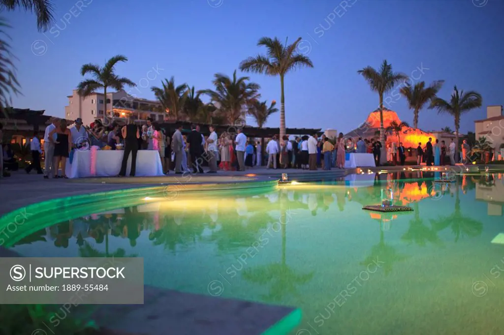 san jose del cabo, baja california, mexico, wedding guests celebrating around the pool at the beach club