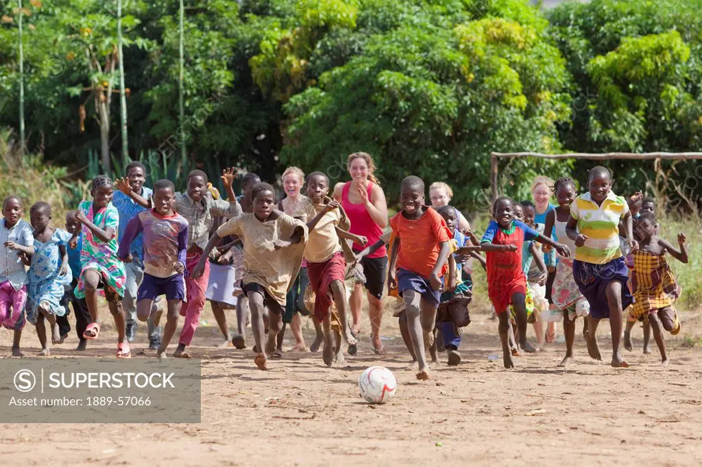 A Group Of Kids Running After A Ball, Manica, Mozambique, Africa