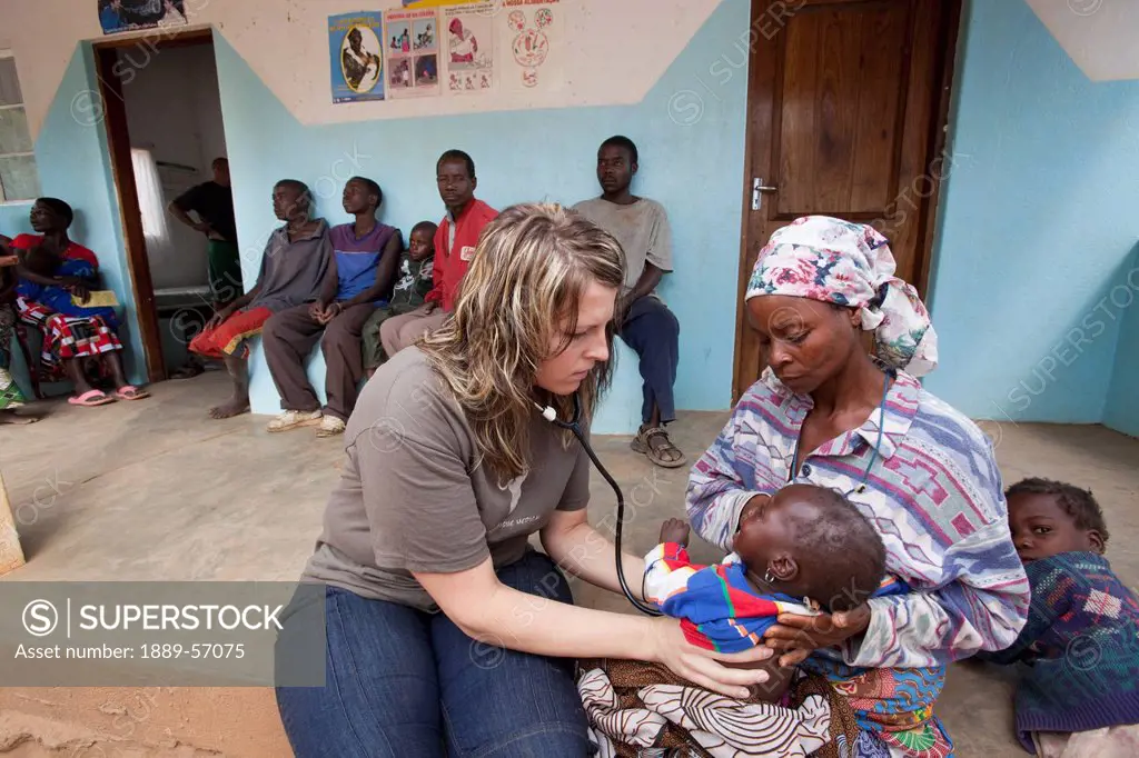 Medical Doctor Does A Check Up On A Child, Manica, Mozambique, Africa