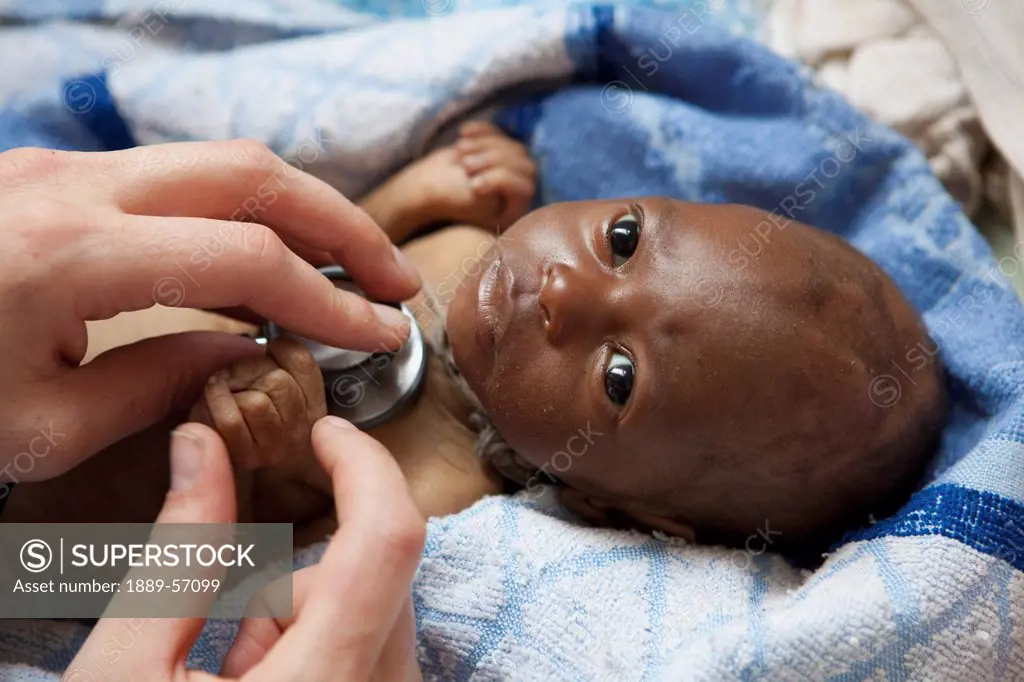 An Infant Dying Of Hiv/Aids Being Cared For By A Medical Worker, Manica, Mozambique, Africa