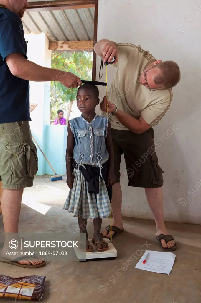 Medical Workers Measuring Height And Weight Of A Young Girl, Manica, Mozambique, Africa