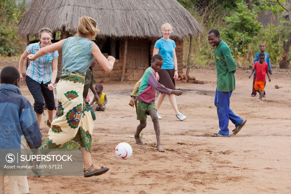 A Group Of People Kicking A Ball, Manica, Mozambique, Africa