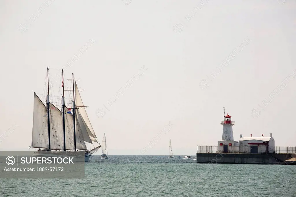 Tall Ship With Sails And A Lighthouse, Port Colborne, Ontario, Canada