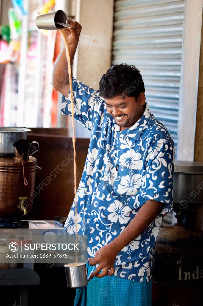 A Man Pouring A Beverage From One Container To Another From High Up, Sathyamangalam, Tamil Nadu, India