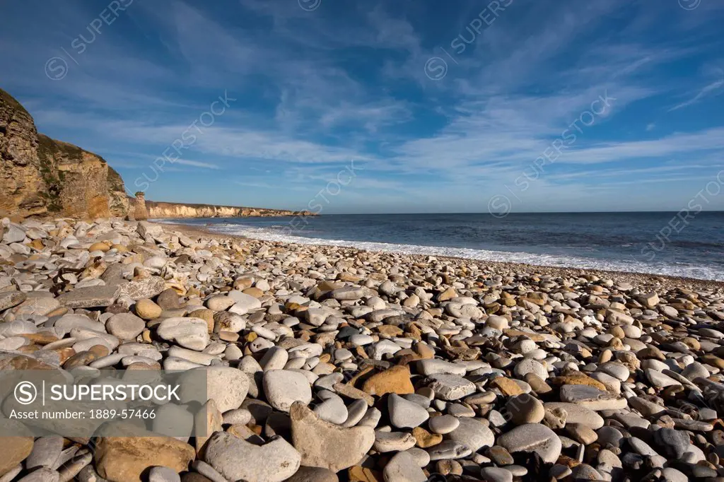 rocks on a beach along the shore, south shields, tyne and wear, england