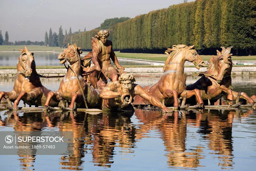 statue of men and horses reflected in a pool, paris, france